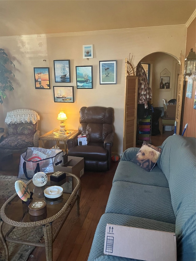 living room with arched walkways, wood-type flooring, and crown molding