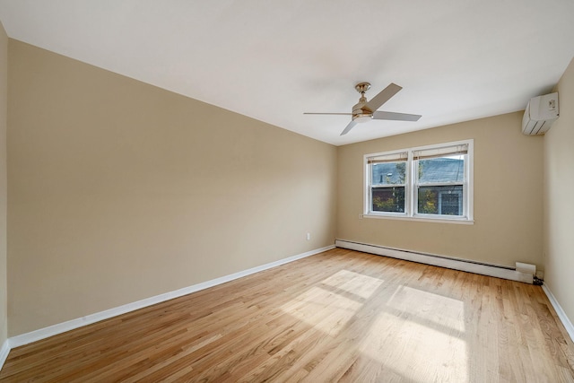 spare room featuring baseboard heating, ceiling fan, light hardwood / wood-style floors, and an AC wall unit