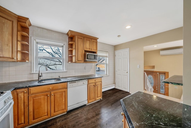 kitchen with sink, white appliances, baseboard heating, dark hardwood / wood-style floors, and an AC wall unit