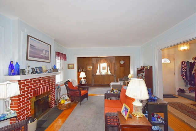 living room with hardwood / wood-style flooring and a brick fireplace