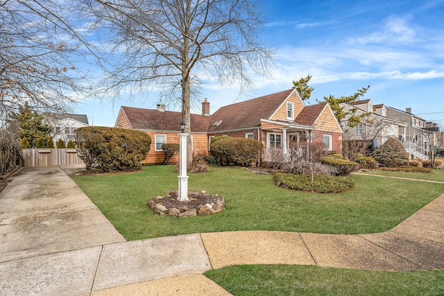 cape cod-style house featuring a front lawn