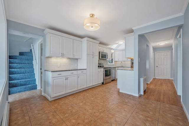 kitchen featuring light stone counters, light tile patterned floors, appliances with stainless steel finishes, white cabinets, and a baseboard heating unit