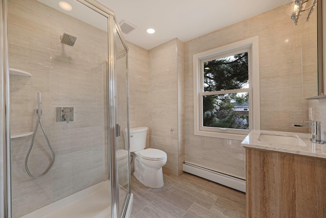 bathroom featuring toilet, an enclosed shower, tile walls, a baseboard radiator, and vanity