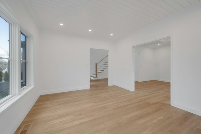 unfurnished room featuring wood ceiling and light hardwood / wood-style flooring