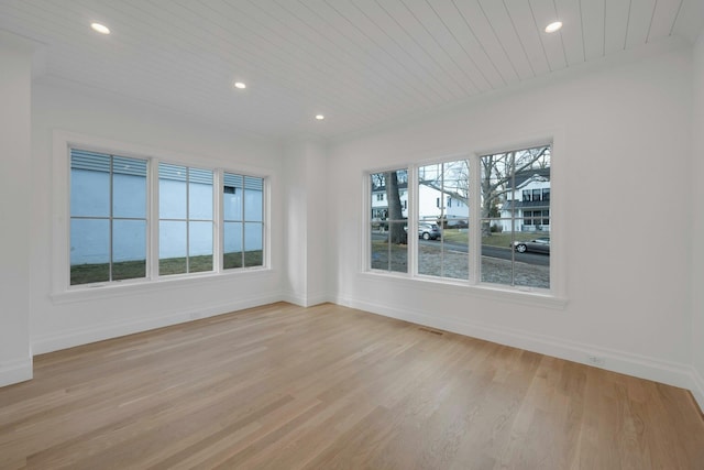 unfurnished room with wood ceiling and light hardwood / wood-style flooring