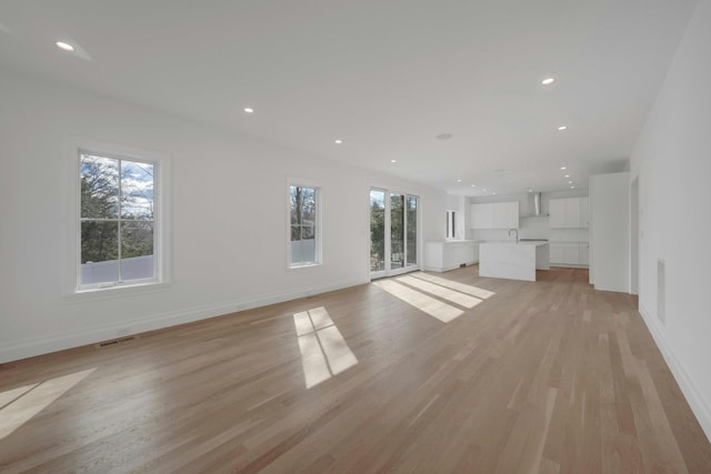 unfurnished living room with light wood-type flooring