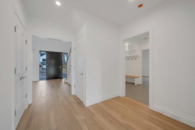 corridor with light hardwood / wood-style floors