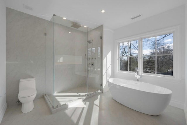 bathroom featuring separate shower and tub and toilet