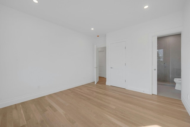 unfurnished bedroom featuring light hardwood / wood-style flooring and ensuite bathroom