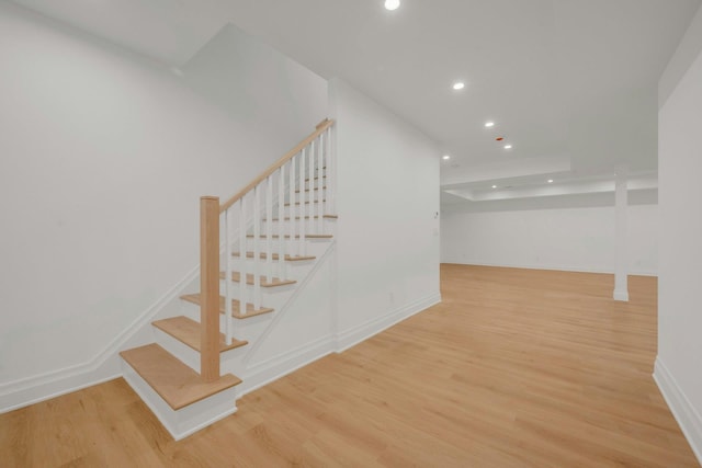 stairway with hardwood / wood-style flooring