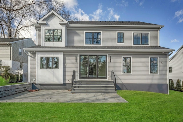 rear view of house featuring a patio area and a lawn