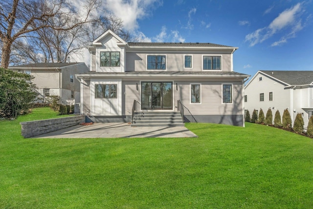 rear view of property with a patio and a lawn