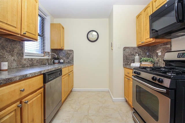 kitchen with sink, backsplash, and appliances with stainless steel finishes