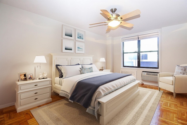 bedroom with ceiling fan, radiator, a wall mounted AC, and light parquet flooring