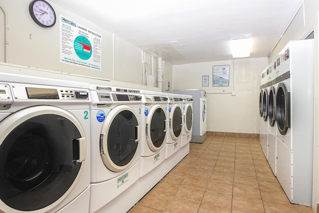 laundry room featuring light tile patterned floors and washer and dryer