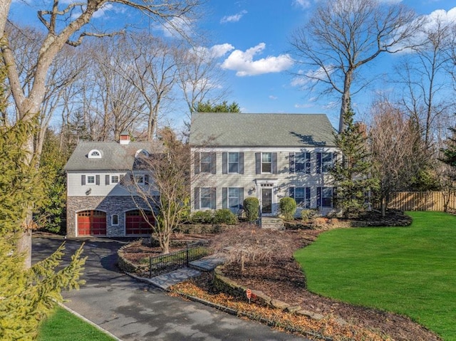 view of front of house featuring a garage and a front yard