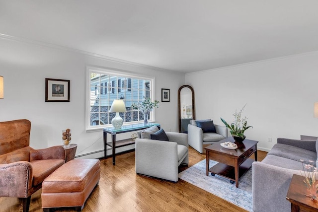 living room featuring ornamental molding, baseboard heating, and light wood-type flooring