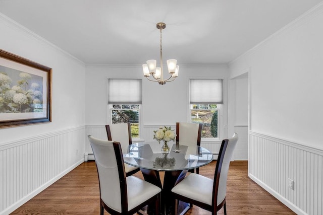 dining area with a notable chandelier, crown molding, dark hardwood / wood-style floors, and baseboard heating