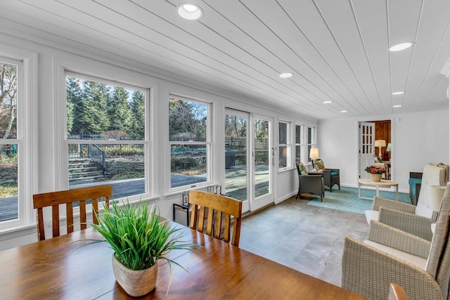 sunroom featuring wooden ceiling and a healthy amount of sunlight