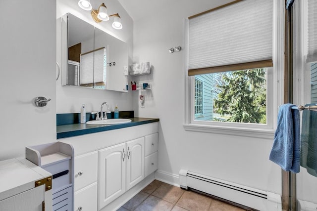 bathroom with tile patterned flooring, a baseboard radiator, and vanity