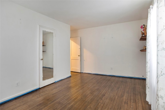 unfurnished room featuring dark wood-type flooring