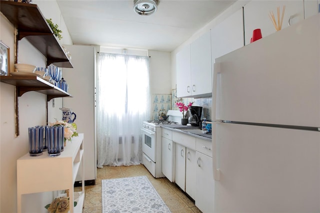 kitchen with backsplash, white appliances, light tile patterned floors, and white cabinets