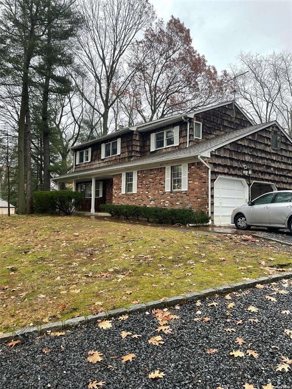 front facade with a garage and a front yard