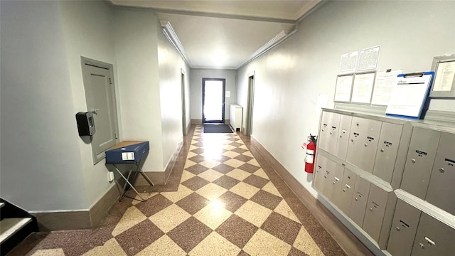 corridor with ornamental molding and a mail area