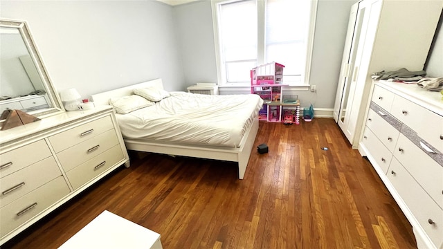 bedroom with dark wood-type flooring