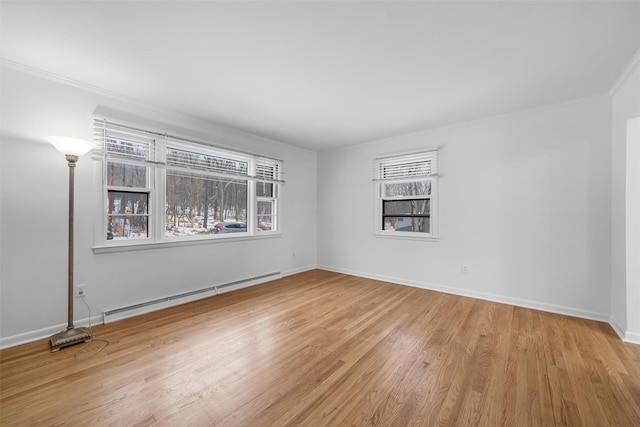 empty room featuring a baseboard heating unit, light hardwood / wood-style flooring, and ornamental molding