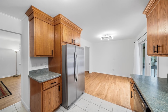 kitchen with stainless steel fridge and light tile patterned floors