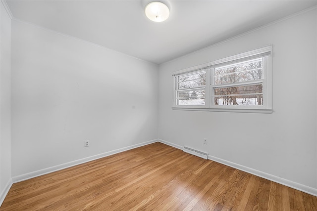 spare room with crown molding and light hardwood / wood-style floors