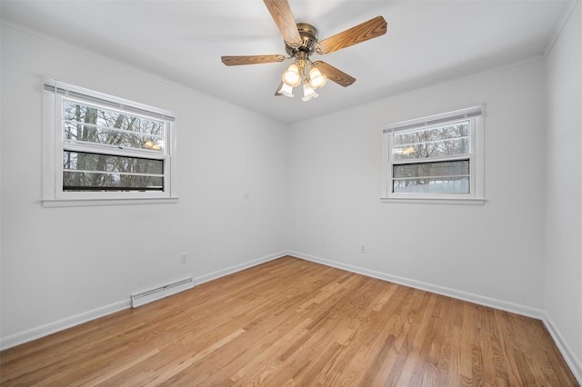 unfurnished room with ceiling fan, a baseboard radiator, a healthy amount of sunlight, and light hardwood / wood-style floors