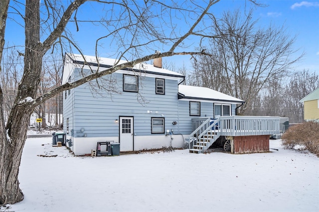 snow covered property featuring a wooden deck