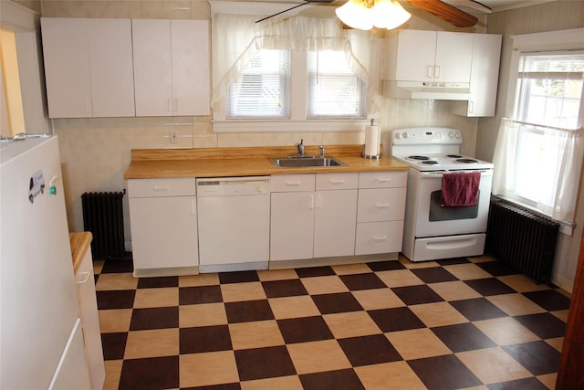 kitchen featuring white cabinetry, white appliances, wooden counters, and radiator