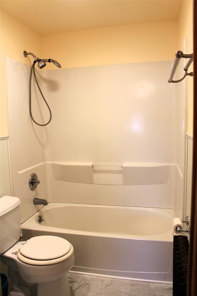 bathroom featuring shower / bathtub combination and toilet