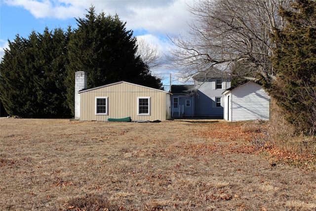 exterior space featuring an outbuilding and a lawn