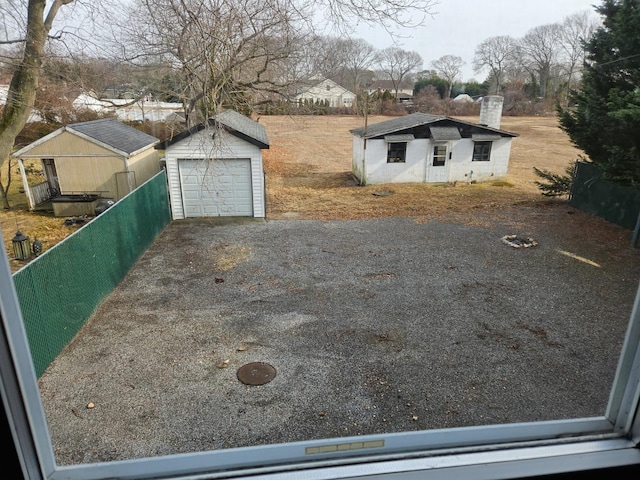 view of yard with a garage and an outdoor structure