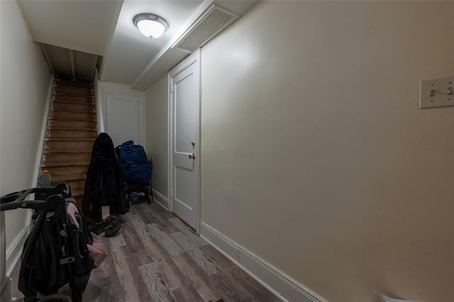 corridor with hardwood / wood-style floors