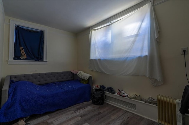 bedroom featuring hardwood / wood-style floors and radiator