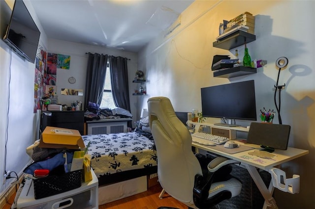 bedroom with hardwood / wood-style floors