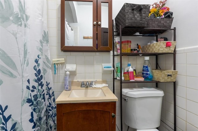 bathroom with vanity, toilet, tile walls, and a shower with curtain