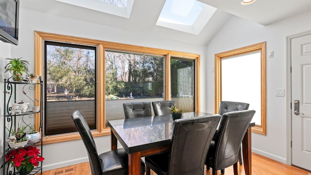 sunroom with lofted ceiling with skylight and a wealth of natural light