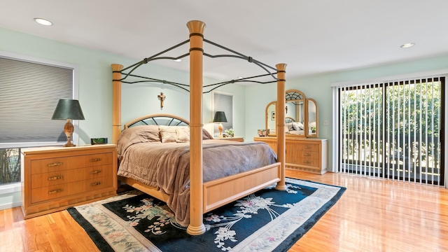 bedroom with access to outside and light hardwood / wood-style floors