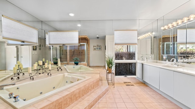 bathroom with vanity, tiled tub, and tile patterned floors