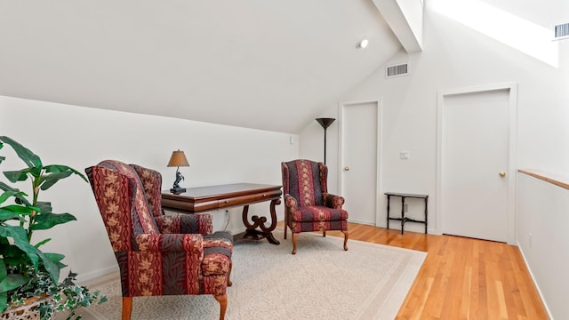 sitting room featuring vaulted ceiling and light hardwood / wood-style floors