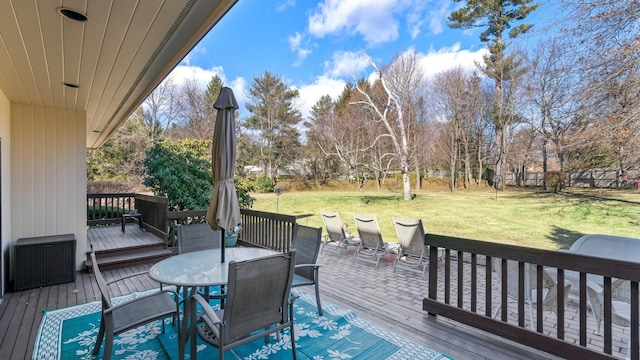 wooden terrace featuring a lawn