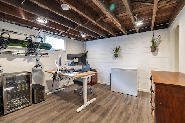 interior space with hardwood / wood-style flooring and beverage cooler