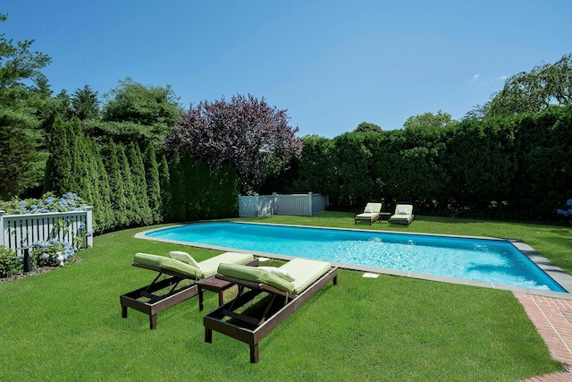 view of swimming pool featuring a lawn