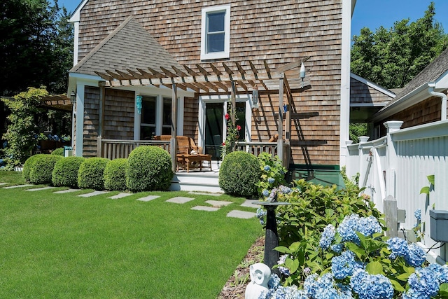 rear view of property with a lawn and a pergola